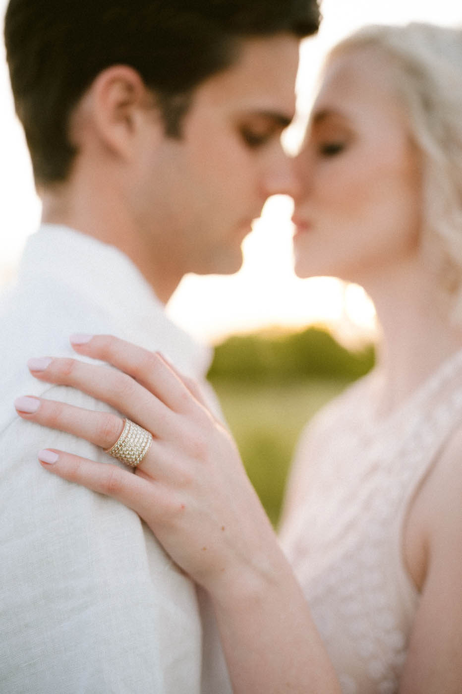 bride_groom_kissing_engagement_ring